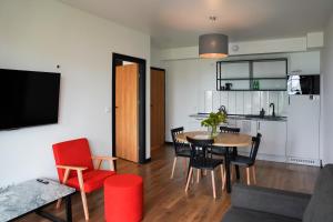 a living room and kitchen with a table and chairs at Moje Miejsce Polanica-Zdrój in Polanica-Zdrój