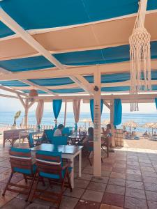 a restaurant with a view of the beach at Ta Kalamakia Apartments in Vatera