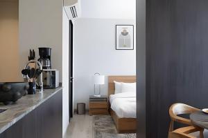 a bedroom with a bed and a table with a coffee maker at Sao Paulo Vertical in Guadalajara +30 photos