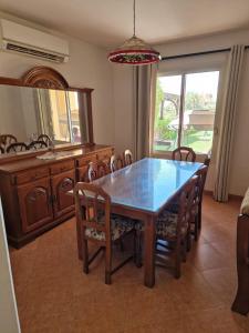 a dining room with a table and chairs and a mirror at Villa Ain Bay Resort Vib Ain Sokhna in Ain Sokhna