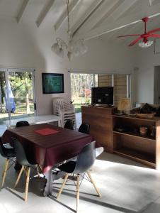 a dining room with a table and chairs at Guindo Cariló in Carilo