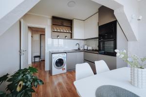 a kitchen with a washer and dryer in a room at Central 1BR Near Piața Centrală & Bus Station in Chişinău