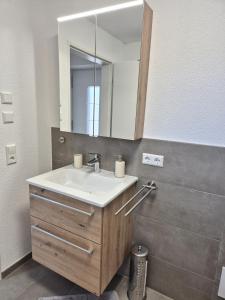 a bathroom with a sink and a mirror at Ferienwohnung Ankerplatz in Schluchsee