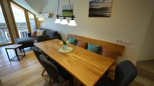 a dining room with a wooden table and chairs at Maierhof in Chieming