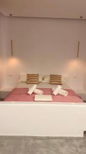 a large white bed with towels on top of it at Rida Village Ksamil Island in Ksamil