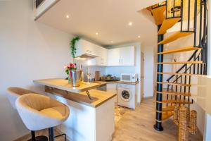 a kitchen with a counter and a staircase in a room at Belvedere Azur Loft in Grimaud
