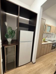 a kitchen with a white refrigerator in a room at Serenity apartment sea view in Souda +17 photos