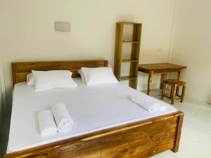 a bedroom with a bed with two pillows on it at AG Villas Arugambay in Arugam Bay