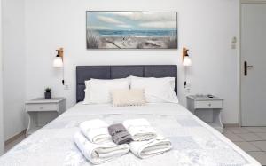 a bedroom with a bed with two towels on it at Anastasia Studios & Apartments in Panormos Skopelos