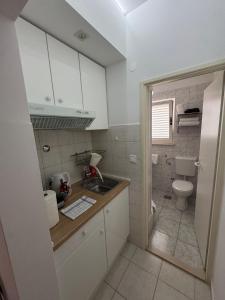 a small bathroom with a sink and a toilet at Apartments Roko in Kaštela +69 photos