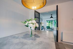 a vase of flowers on a table in a room at Family-Friendly Galway 3 Bed House - Sleeps 6 in Galway
