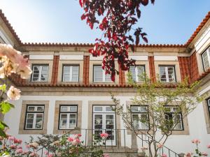 a building with windows and flowers in front of it at Forrester Essence Douro Hotel - by Unlock Hotels in Alijó