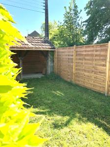 ArdentesにあるCharmante maison avec garageの建物のある庭の木製の柵