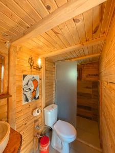 a wooden bathroom with a toilet and a sink at 11-11Shambala in Fethiye