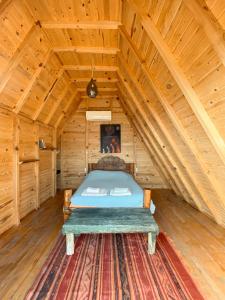 a bedroom with a bed in a wooden attic at 11-11Shambala in Fethiye