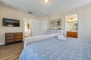 a bedroom with a bed with a blue bedspread at The Hearth Home - 4 Suites in Kissimmee +73 photos