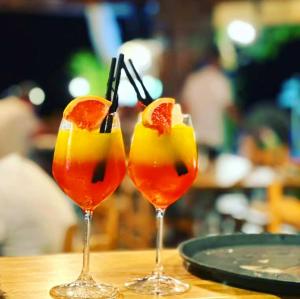 two glasses with fruit on top of a table at Hotel Elisabeta Borsh in Borsh