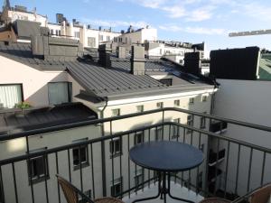 a balcony with a table and some buildings at Luxhousing apartment with balcony in Helsinki