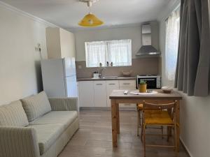 a living room with a couch and a table and a kitchen at Nefeli's Hut in Mytilene
