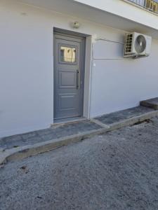 a door with a speaker next to a building at Nefeli's Hut in Mytilene