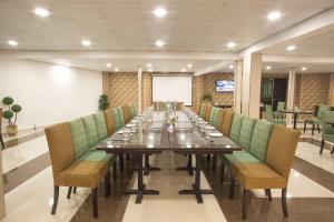 a long dining room with a long table and chairs at Hotel Sunway Murree in Murree