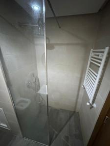 a bathroom with a shower with a glass door at Appartement a jardin carthage tunis in Sidi Daoud +11 photos