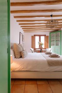 a bedroom with a large bed with a wooden ceiling at Castelar Suite, Villajoyosa Old Town, Balcony and Terrace, Seaview in Villajoyosa