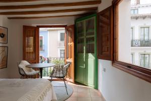 a room with a balcony with a table and chairs at Castelar Suite, Villajoyosa Old Town, Balcony and Terrace, Seaview in Villajoyosa +15 photos