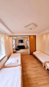 a bedroom with two beds and a living room at Cozy Garden Villa in Ventspils