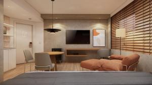 a bedroom with a television and a table and chairs at TW Cyclinn Vila Olimpia in São Paulo