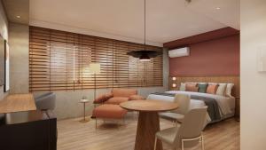 a bedroom with a bed and a table and chairs at TW Cyclinn Vila Olimpia in São Paulo