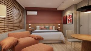 a bedroom with a bed and a table and chairs at TW Cyclinn Vila Olimpia in São Paulo