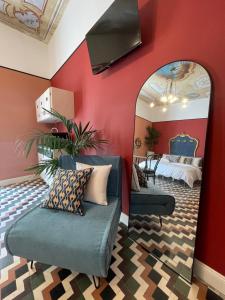 a living room with red walls and a mirror at Casa Patrizia Charme B&b in Montenero di Bisaccia