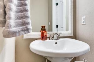 a bathroom with a white sink and a mirror at 7 Mi to Vancouver Waterfront Sleek Home with Yard! in Vancouver +21 photos