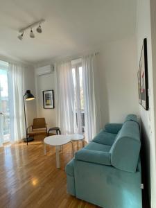 a living room with a blue couch and a table at Docking House in Lido di Ostia