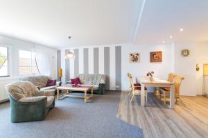 a living room with a couch and a table and chairs at Ferienwohnung Gauger-Binz auf Rügen in Binz