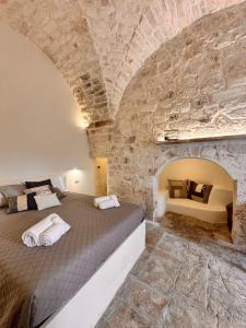 a bedroom with a bed in a stone wall at Bianca Ostuni in Ostuni