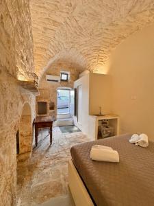 a bedroom with a bed in a stone building at Bianca Ostuni in Ostuni +1 photo