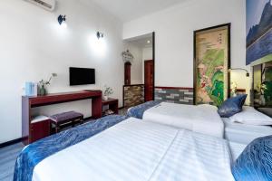 Postel nebo postele na pokoji v ubytování Guilin Mingyuan Boutique Hotel