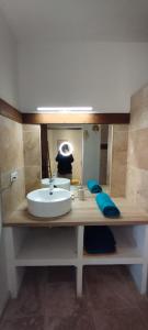 a bathroom with a sink and a mirror at Bel appartement du centre ancien in Beaumes-de-Venise +23 photos