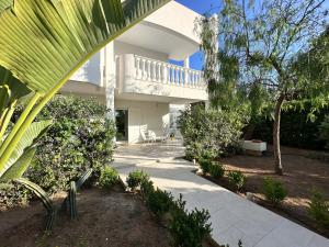 a large white house with a balcony and a patio at tulip 59 in Gallipoli