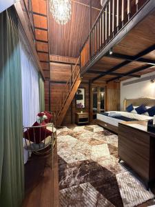 a bedroom with a staircase and a bed and a chair at Boulevard Resorts in Kakkadampoyil +39 photos