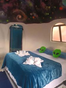 a room with two beds with towels on them at Pousada Lunazem in Alto Paraíso de Goiás