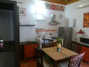 a kitchen with a table and chairs and a kitchen with a refrigerator at Casa Silva - Intero Appartamentino a Carini in Carini
