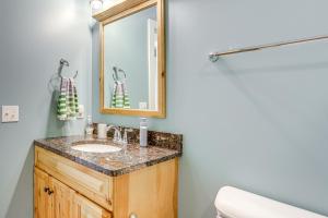 a bathroom with a sink and a mirror at Walk to Lake Kelleys Island Gem with Deck! in Kelleys Island +16 photos