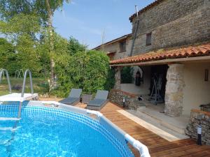 a swimming pool in front of a house at Le Quereau in Saint-Macoux