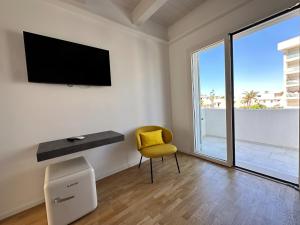 a white room with a desk and a yellow chair at tulip 59 in Gallipoli +53 photos
