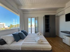 a bedroom with a large bed with a large window at tulip 59 in Gallipoli