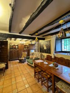 a living room with a table and a couch at Casa rural carrales in Matienzo +42 photos