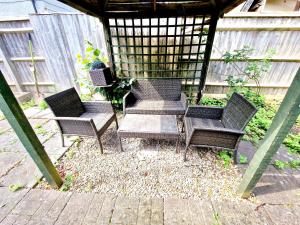 a group of chairs sitting in a gazebo at Sweet Rose Guest House Room 2 in Oxford